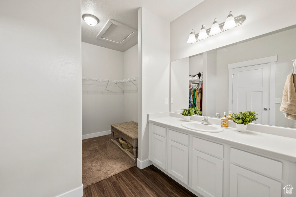 Bathroom with vanity and hardwood / wood-style floors