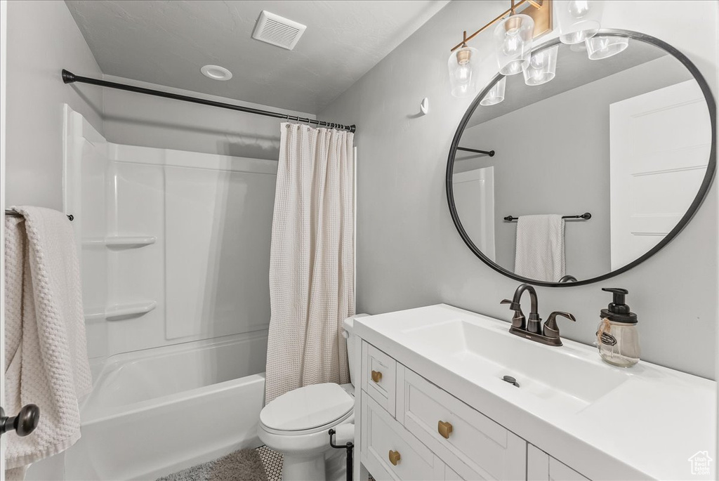 Full bathroom featuring tile flooring, toilet, shower / bath combo, and vanity