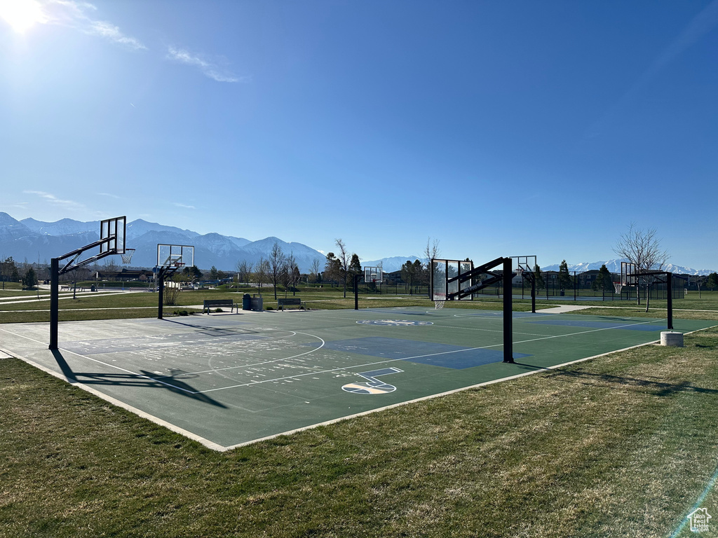 View of sport court with a lawn and a mountain view