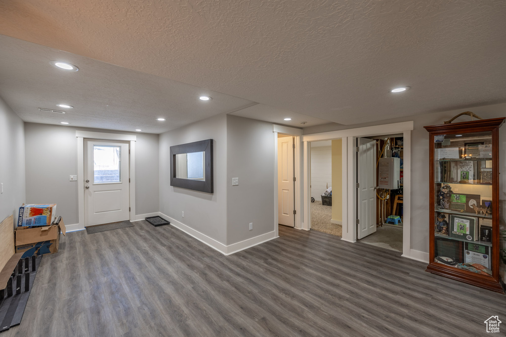 Entryway featuring a textured ceiling and dark hardwood / wood-style flooring