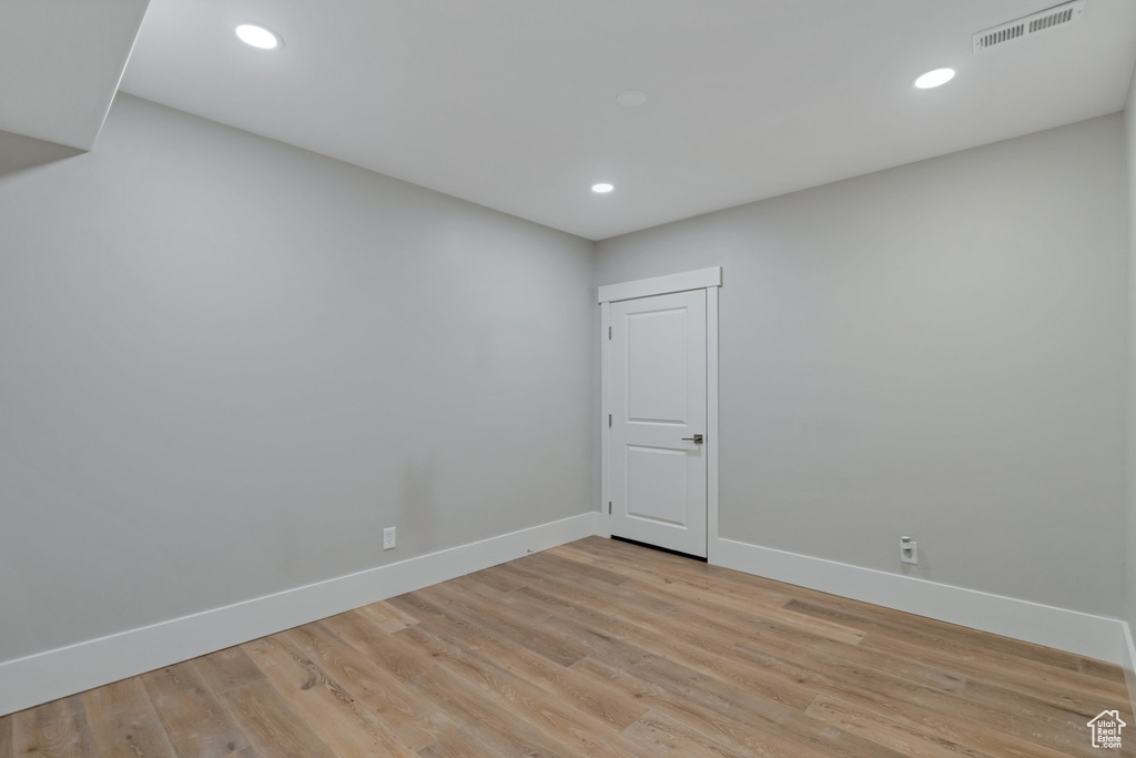 Empty room with light hardwood / wood-style floors