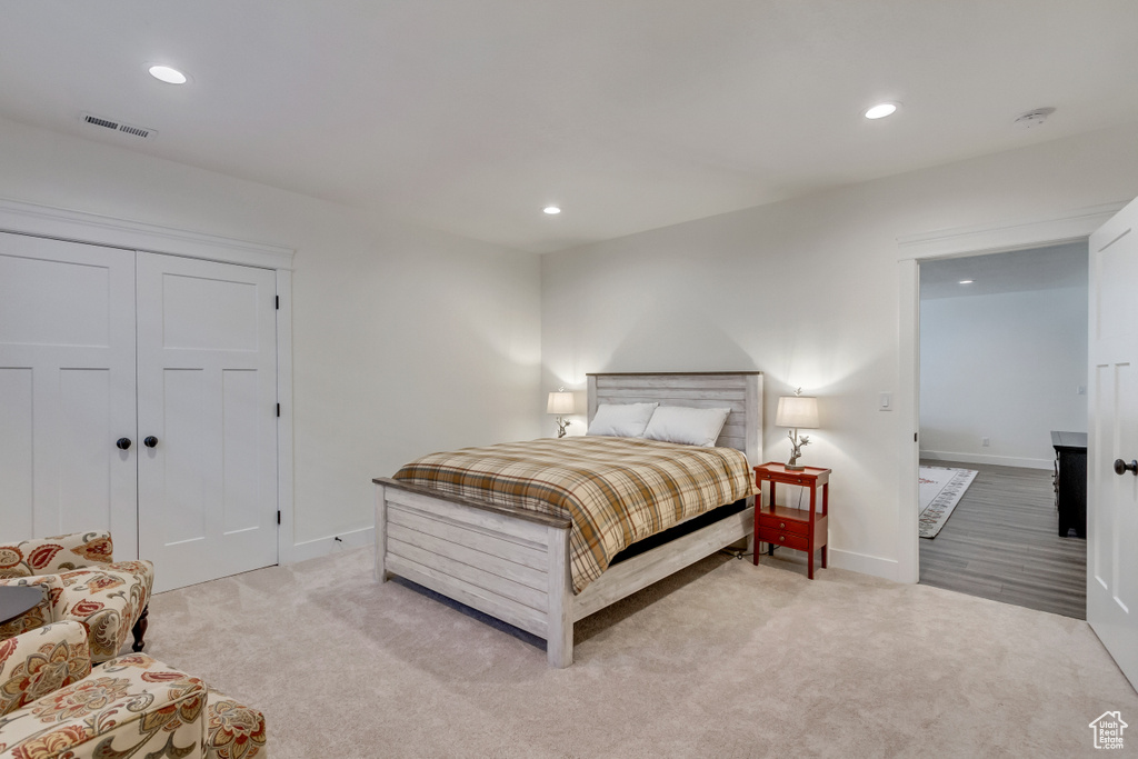 Bedroom with a closet and light carpet