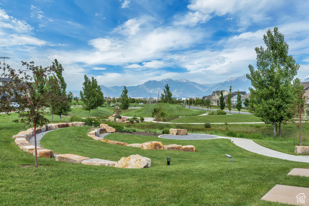 Surrounding community with a lawn and a mountain view