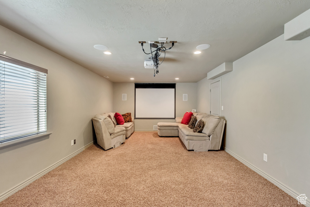 Home theater featuring light carpet
