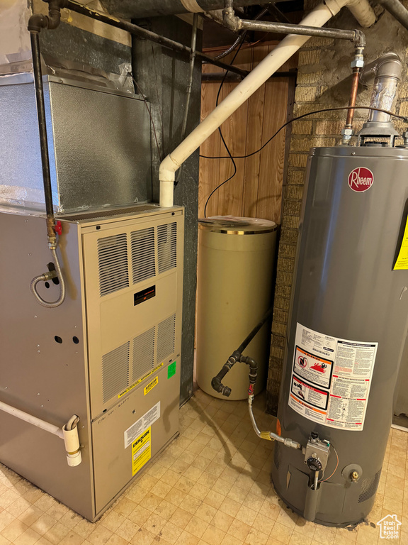 Utility room featuring gas water heater and heating utilities