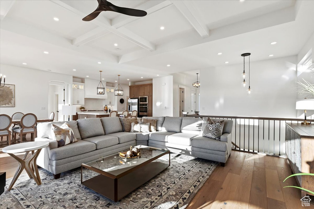 Living room with coffered ceiling, ceiling fan, hardwood / wood-style floors, and beamed ceiling