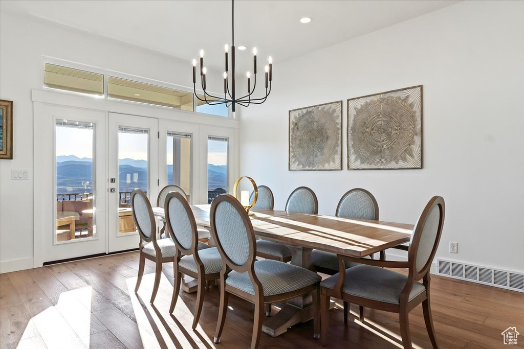 Dining area featuring a chandelier, french doors, a mountain view, and light hardwood / wood-style flooring
