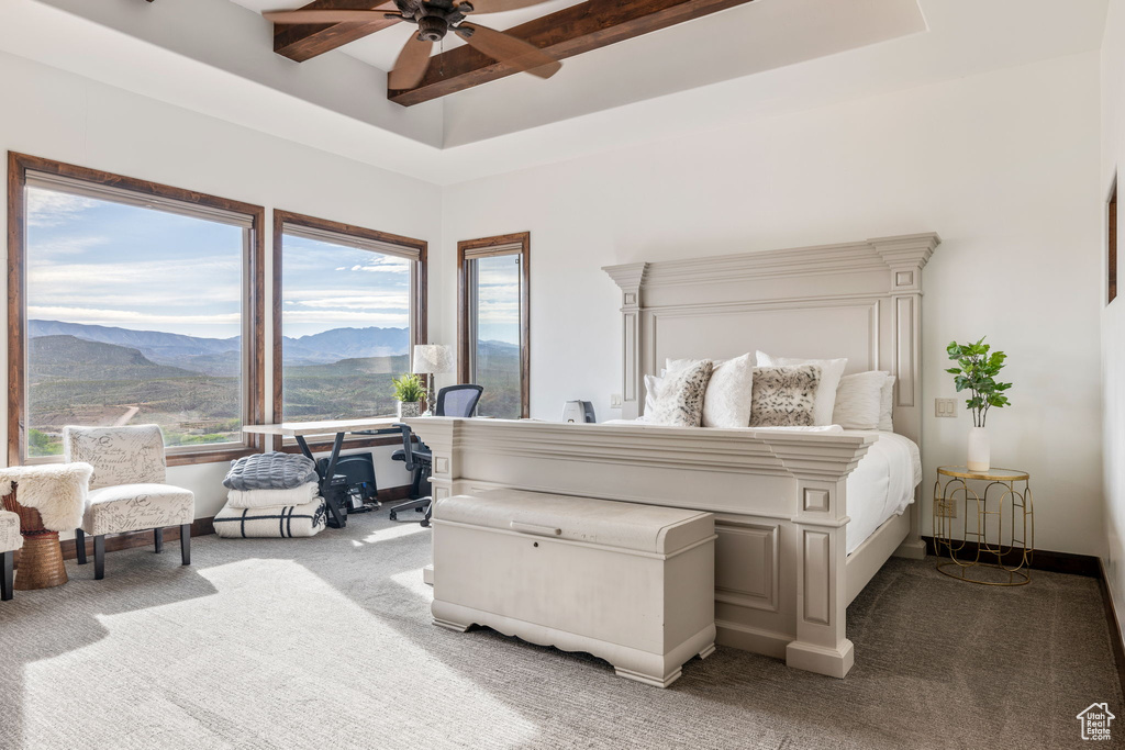 Bedroom featuring carpet floors, ceiling fan, a mountain view, and multiple windows