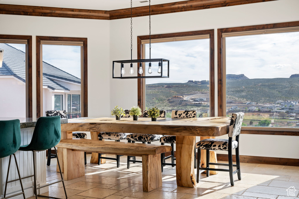 Dining space with a chandelier, a mountain view, and light tile floors