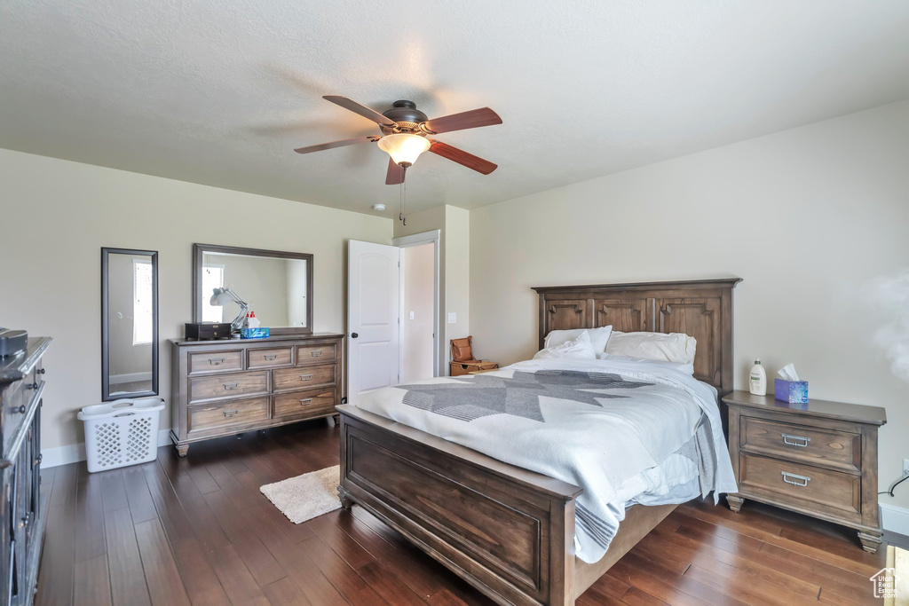 Bedroom featuring ceiling fan and dark hardwood / wood-style floors