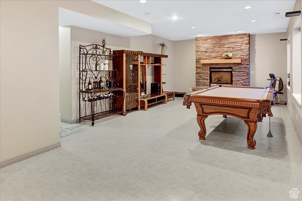 Playroom featuring light tile floors, pool table, and a fireplace