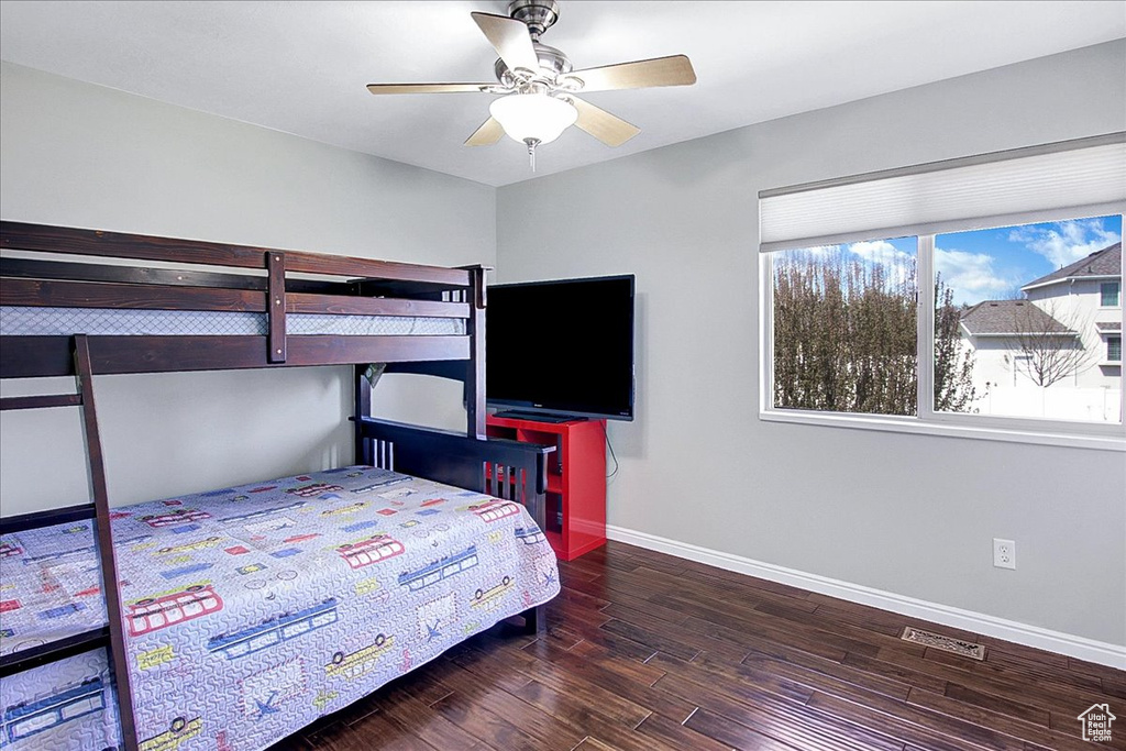 Bedroom featuring ceiling fan and dark hardwood / wood-style flooring