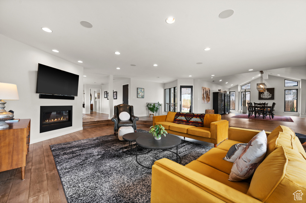 Living room featuring lofted ceiling, dark hardwood / wood-style floors, and plenty of natural light