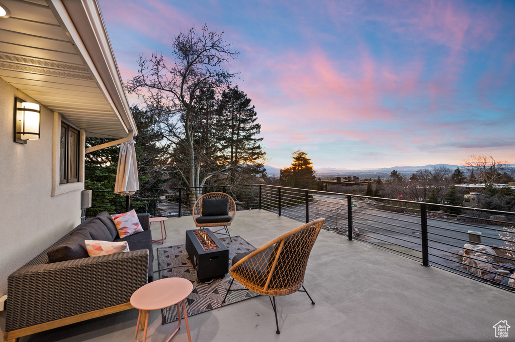 Patio terrace at dusk featuring an outdoor living space with a fire pit