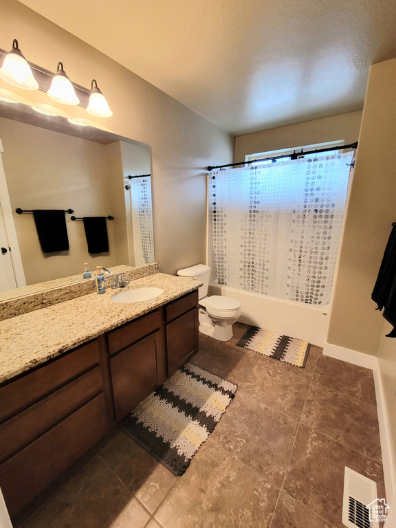Bathroom with tile flooring, toilet, and vanity