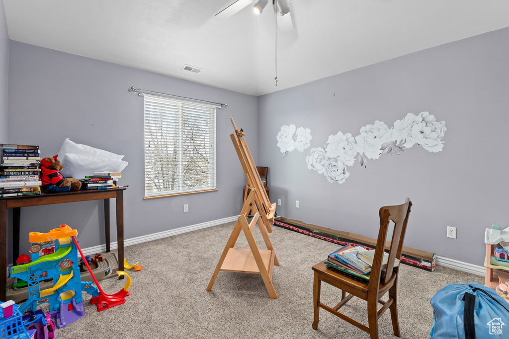 Recreation room featuring ceiling fan and light carpet