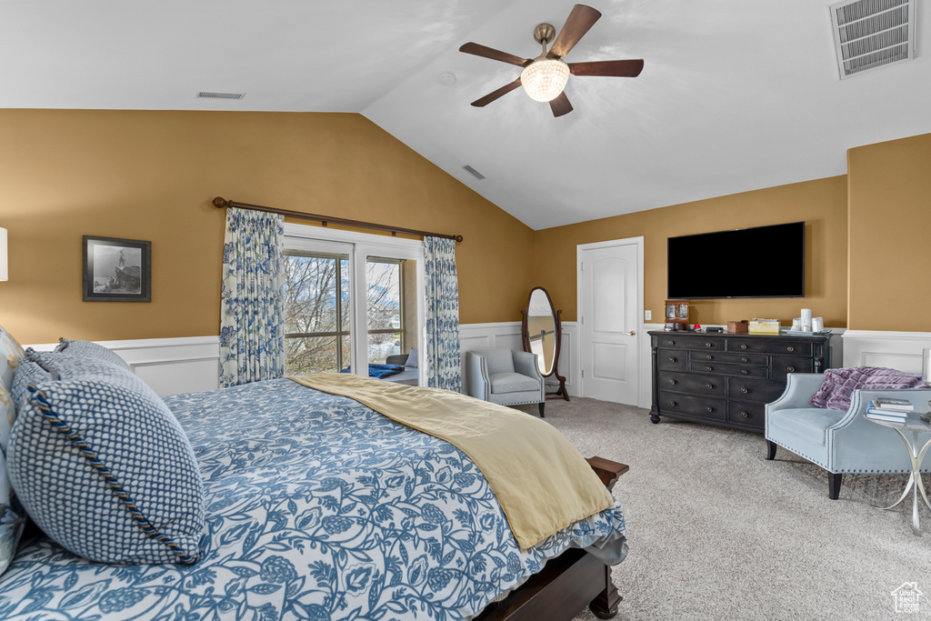 Carpeted bedroom featuring ceiling fan, lofted ceiling, and access to outside