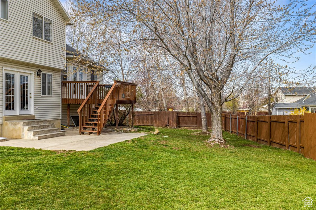 View of yard with a patio area and a deck