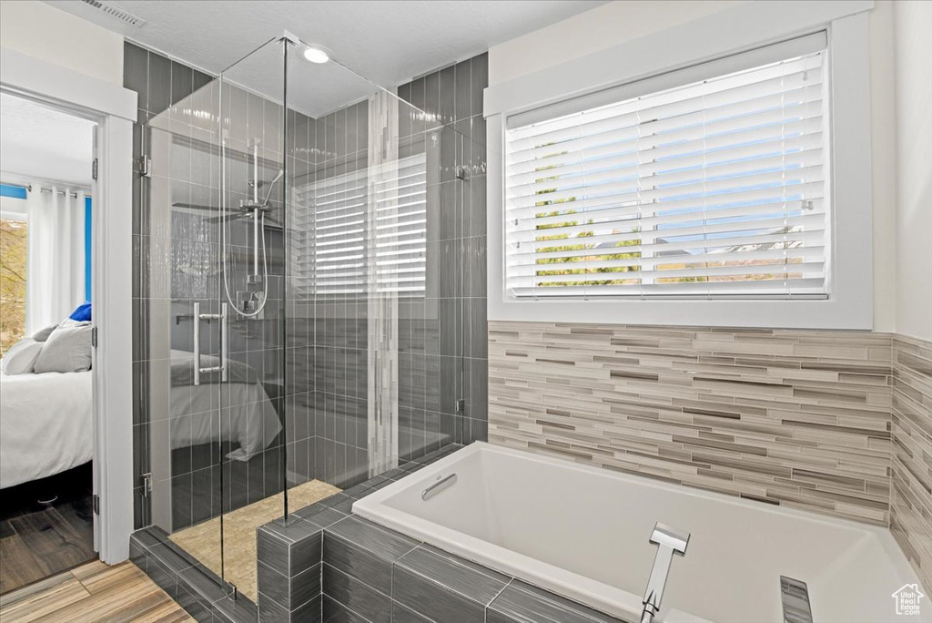Bathroom featuring a shower with door and hardwood / wood-style flooring