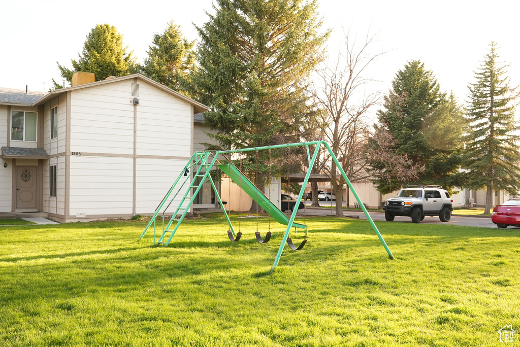 View of jungle gym with a yard