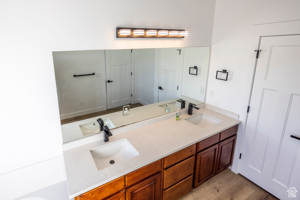 Bathroom with hardwood / wood-style floors and dual vanity