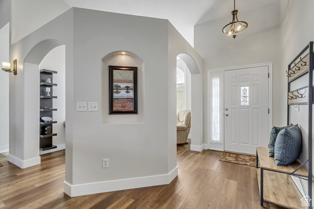 Foyer featuring hardwood / wood-style floors and vaulted ceiling