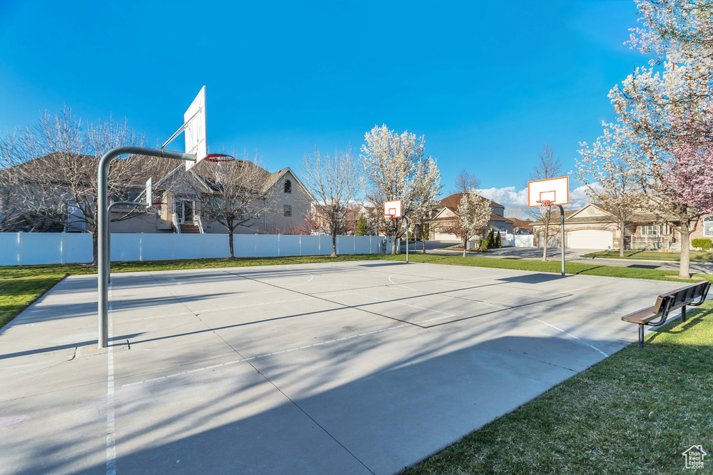 View of nearby features featuring a yard and basketball court