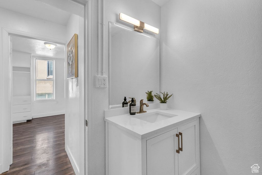 Bathroom with hardwood / wood-style floors and vanity