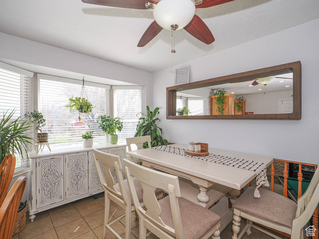 Dining space featuring ceiling fan and light tile floors