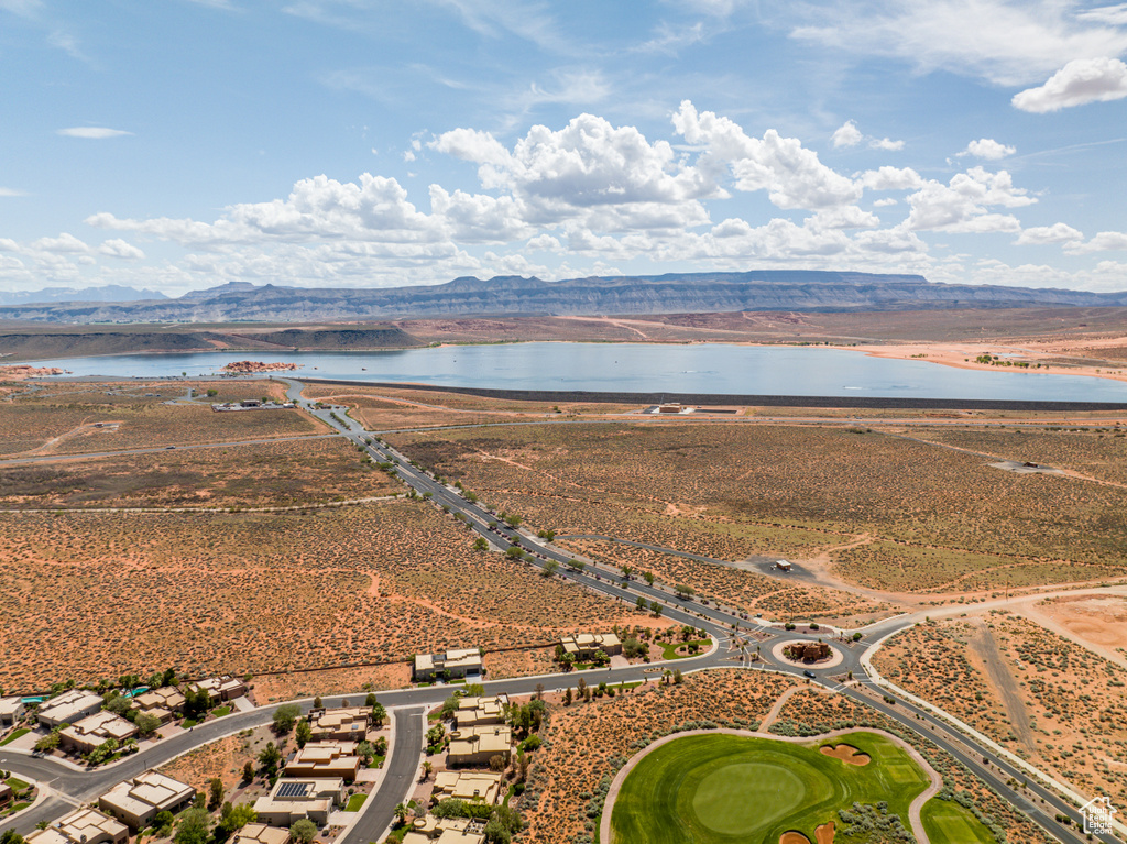 Birds eye view of property with a water and mountain view