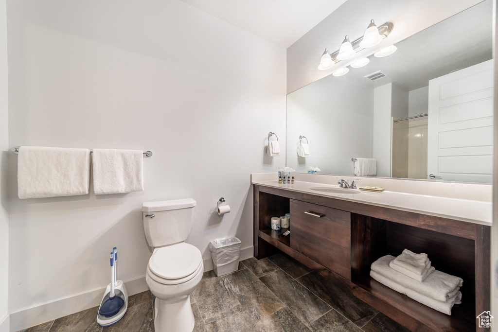 Bathroom featuring toilet, vanity, and wood-type flooring