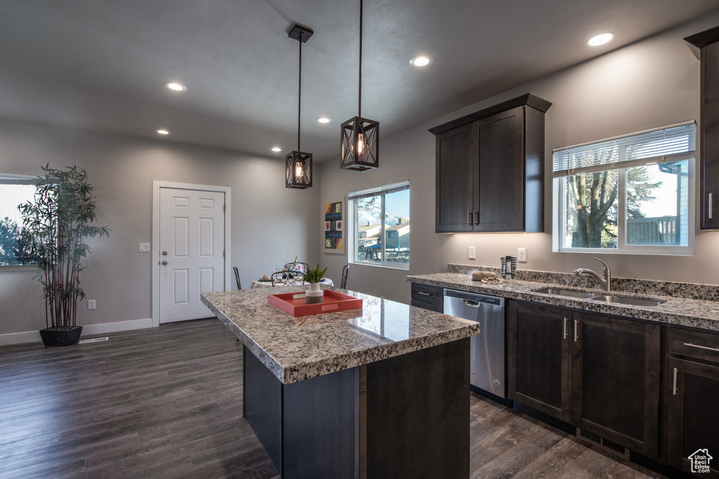 Kitchen featuring sink, a center island, dark hardwood / wood-style floors, and stainless steel dishwasher