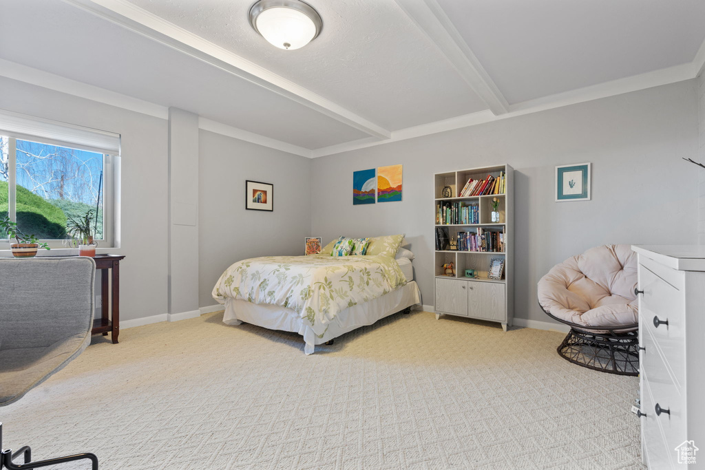 Carpeted bedroom featuring beamed ceiling