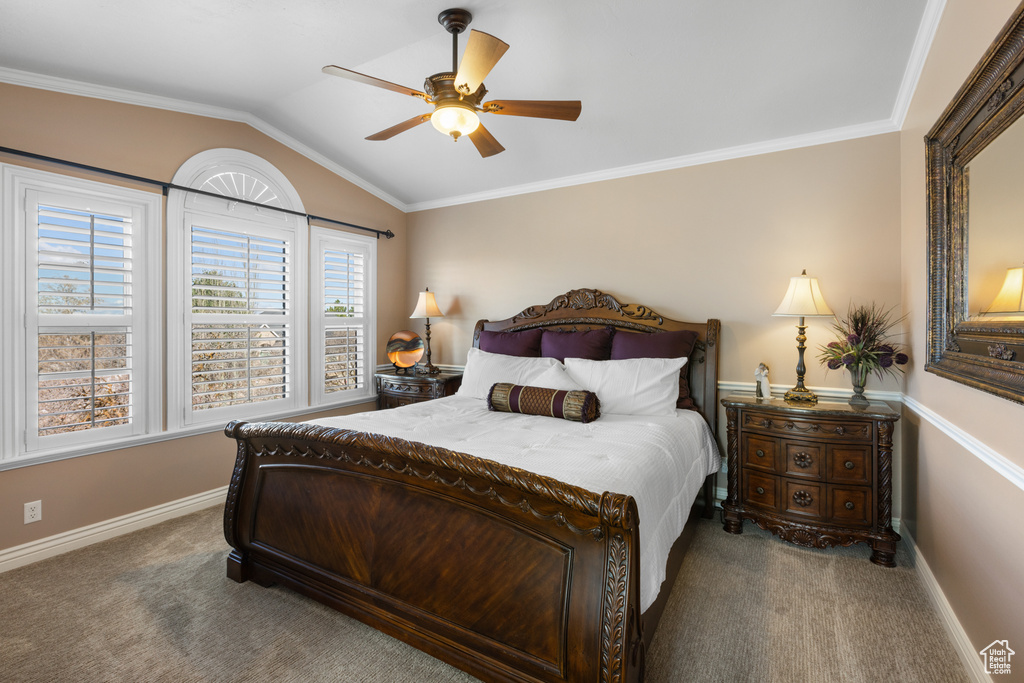 Bedroom featuring ornamental molding, lofted ceiling, ceiling fan, and dark colored carpet