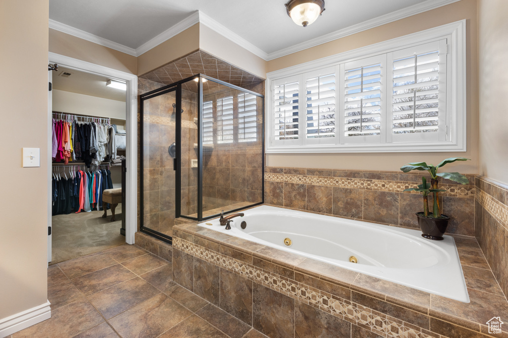 Bathroom with tile flooring, plus walk in shower, and ornamental molding