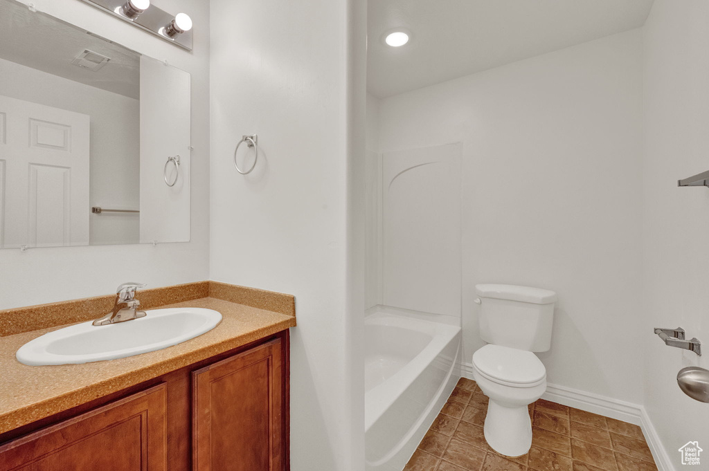 Full bathroom with vanity, tile flooring, shower / washtub combination, and toilet
