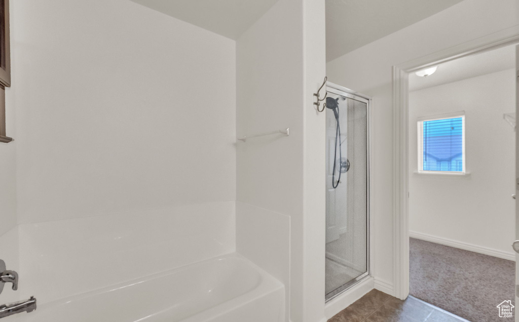 Bathroom with tile floors and separate shower and tub