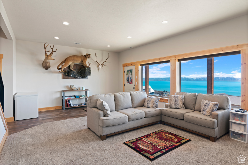 Living room with a water view and hardwood / wood-style floors