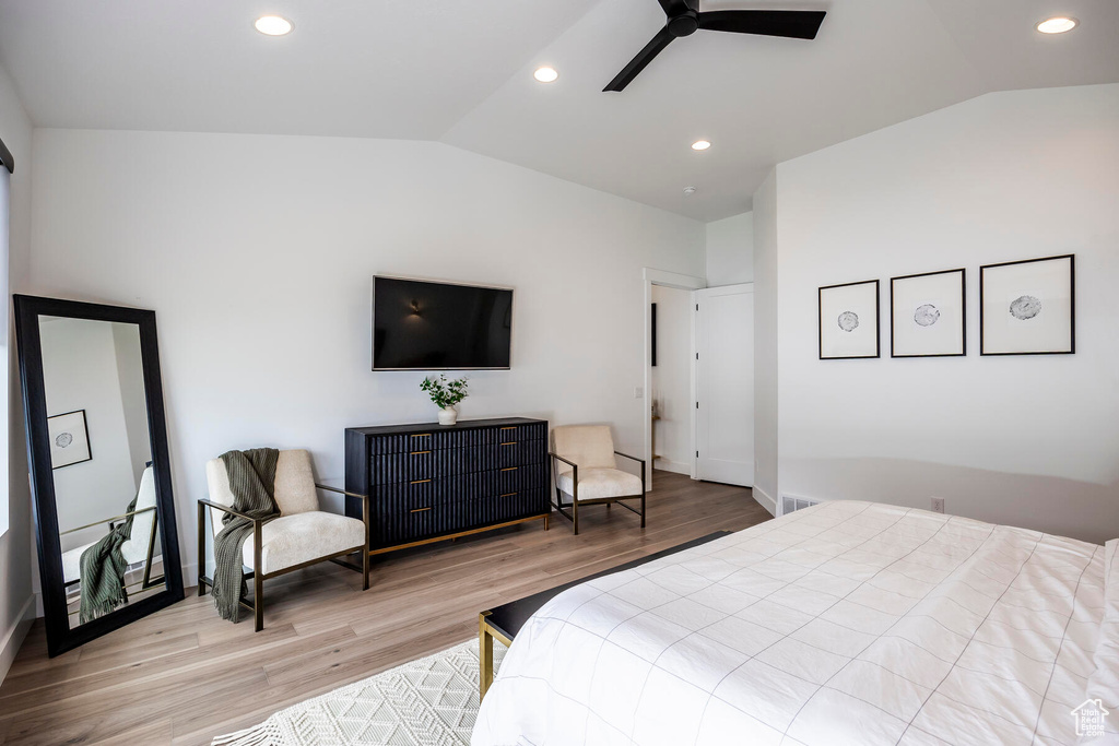 Bedroom featuring light hardwood / wood-style flooring, ceiling fan, and lofted ceiling