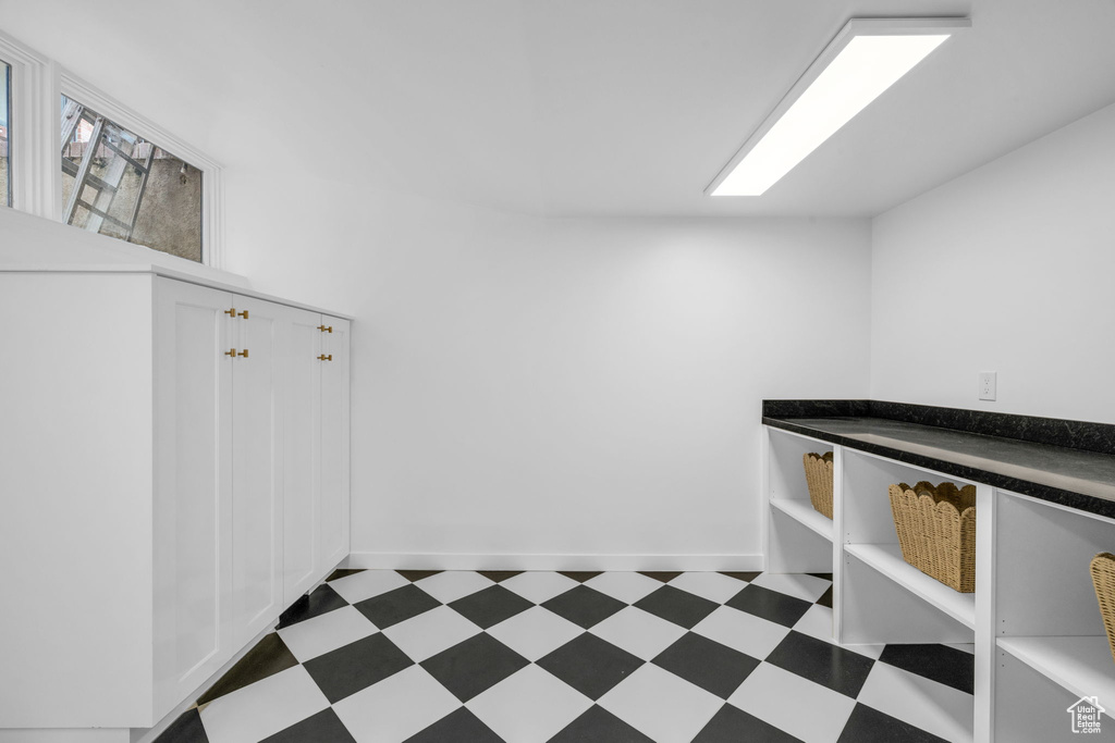 Miscellaneous room with dark tile flooring