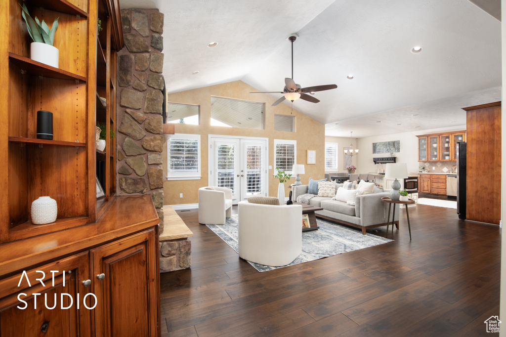 Living room featuring ceiling fan, french doors, vaulted ceiling, and dark hardwood / wood-style flooring