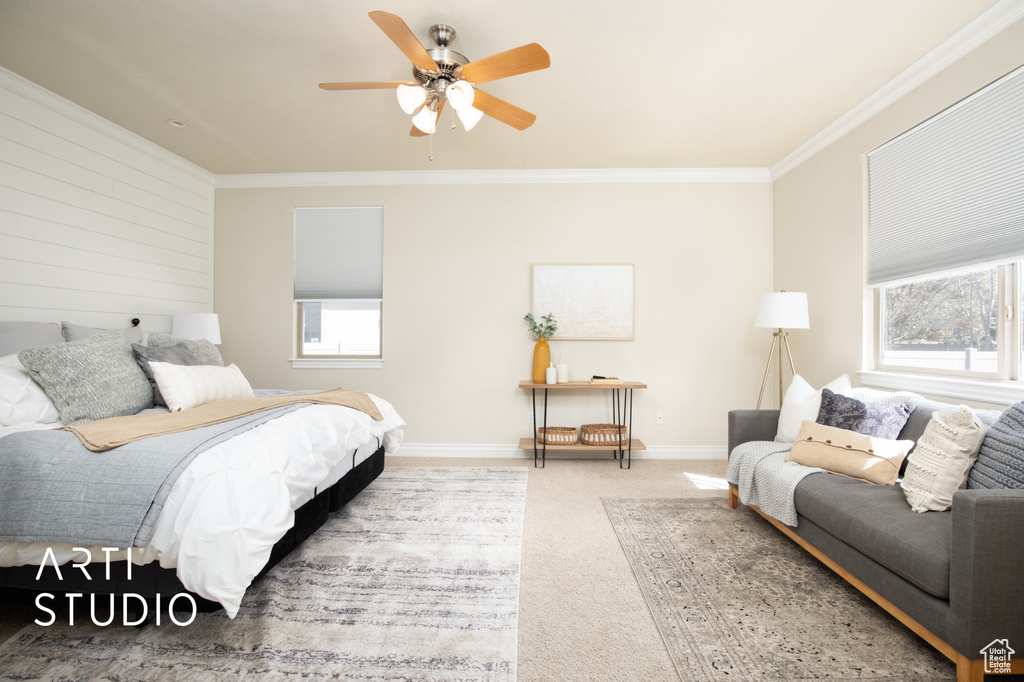 Carpeted bedroom featuring crown molding, ceiling fan, and multiple windows