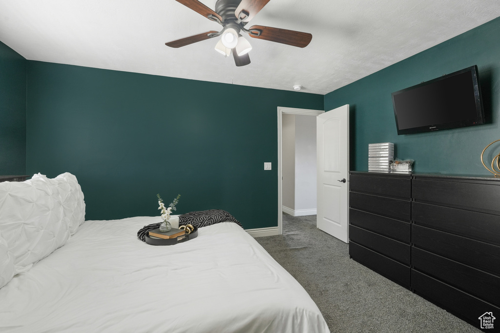 Carpeted bedroom with ceiling fan
