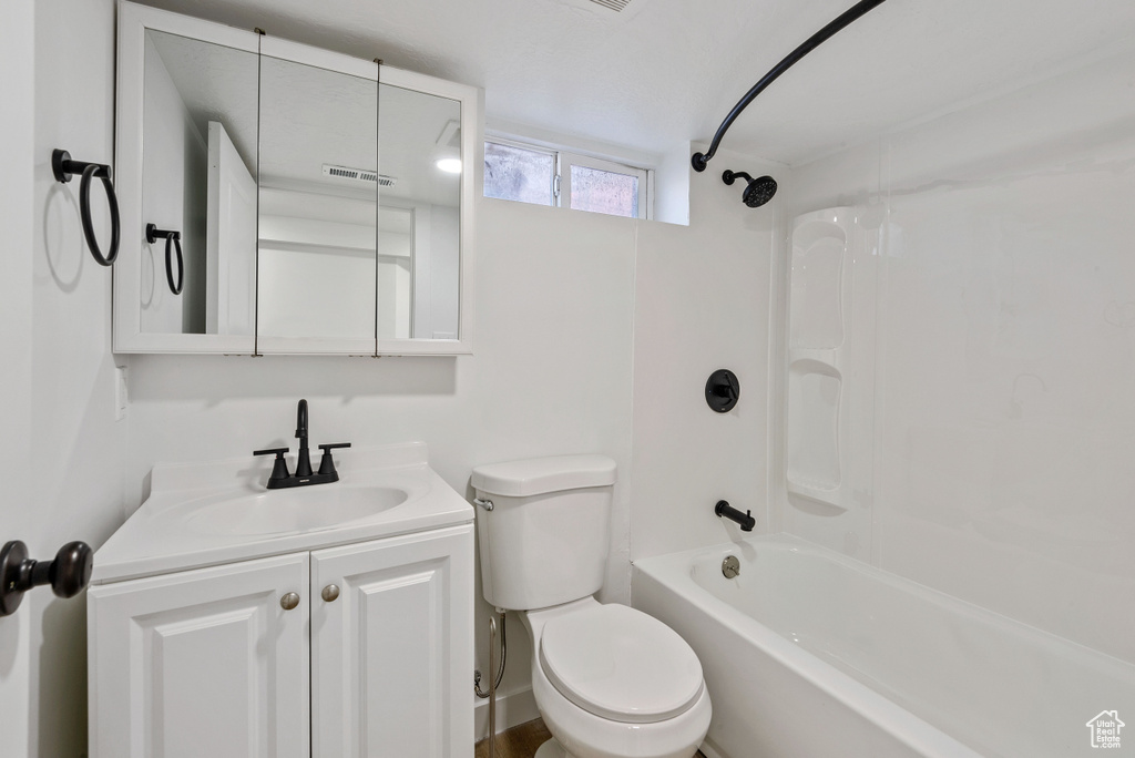 Full bathroom with toilet, vanity, and bathtub / shower combination