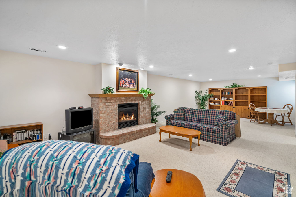 Living room featuring a brick fireplace and light carpet