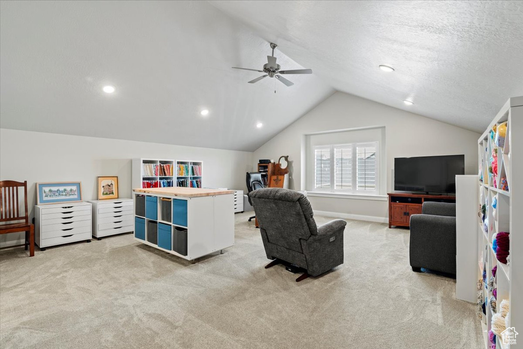 Interior space featuring lofted ceiling, ceiling fan, and a textured ceiling