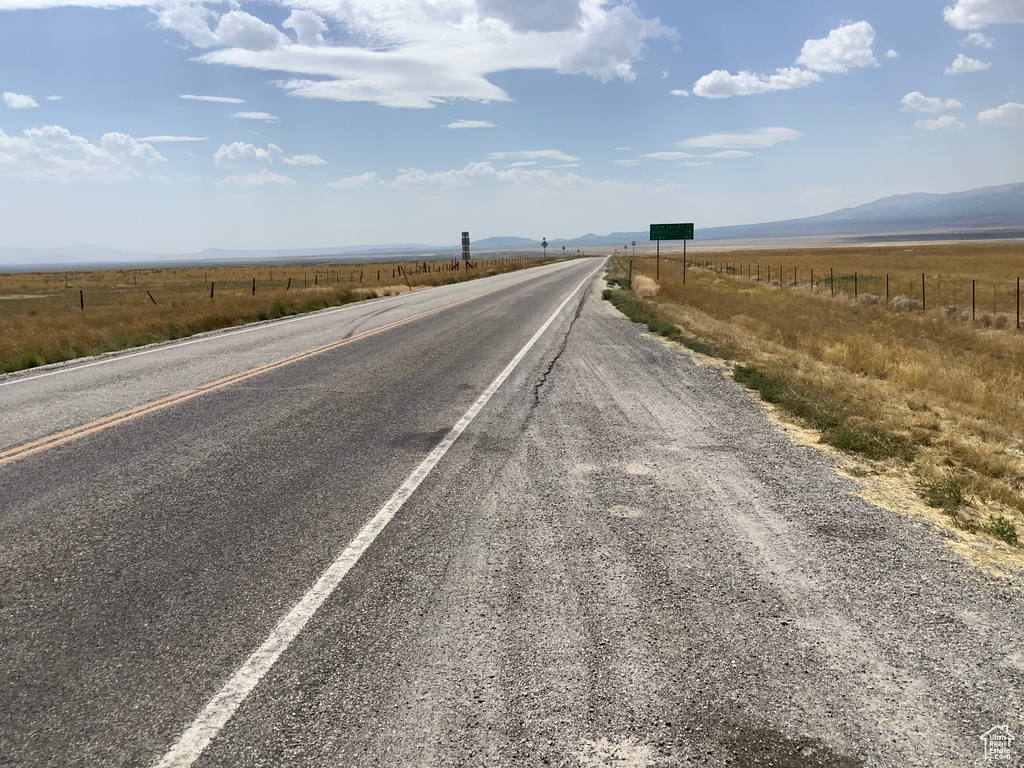 View of road with a rural view and a mountain view