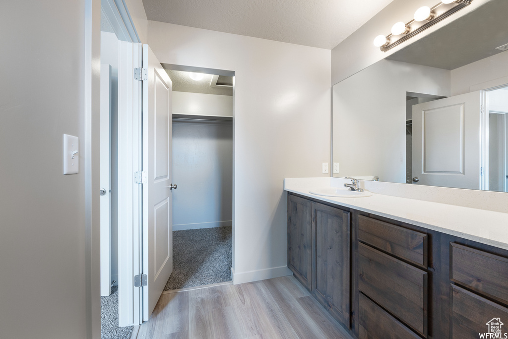 Bathroom with vanity and hardwood / wood-style floors