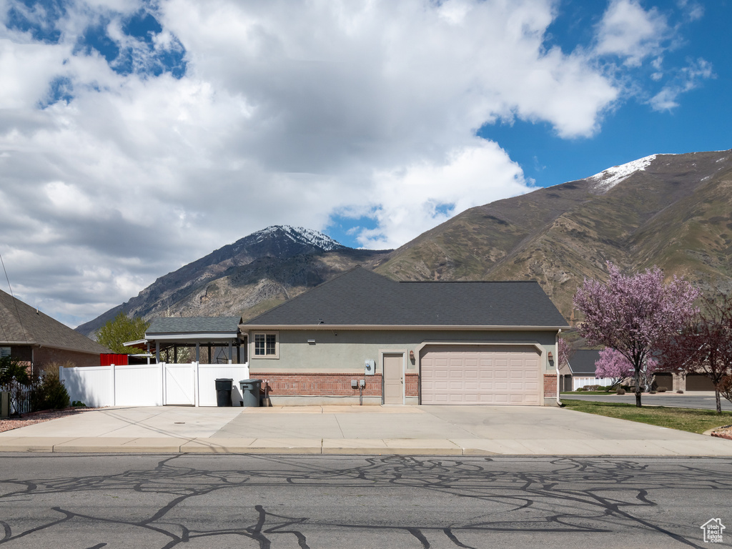 View of front facade featuring a mountain view and a garage