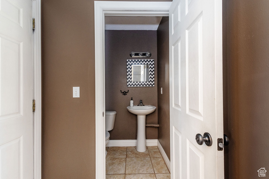 Bathroom featuring tile flooring and toilet